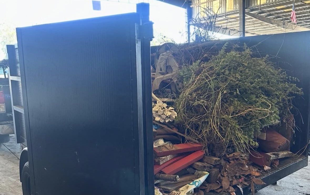 Brush, branches and yard waste loaded into a Monterey Bay Junk Services dump trailer for sorting